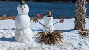 Snowmen next to a palm tree after rare Florida snowfall